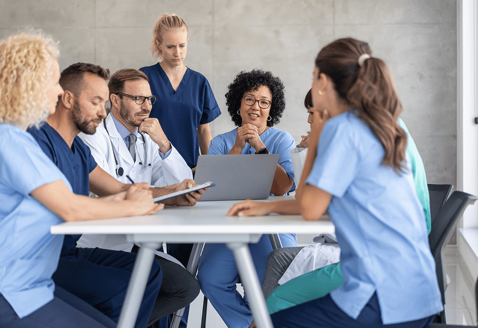 Medical team discussing patient care in a meeting room.
